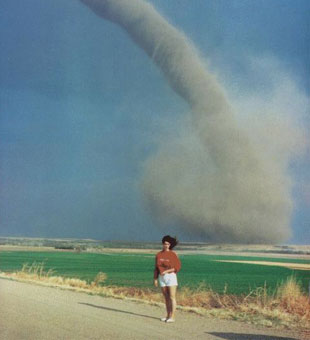 Woman standing in front of a gaint tornado